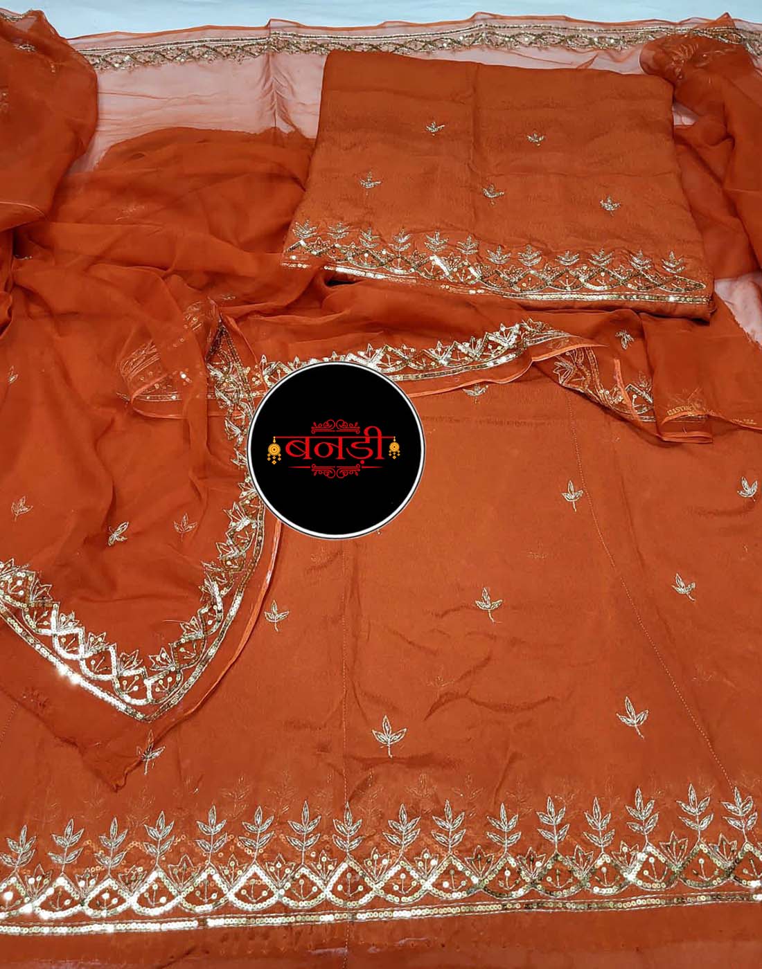 Upada Suit in Rust Color with Jodhpur Tikli Mix Handwork