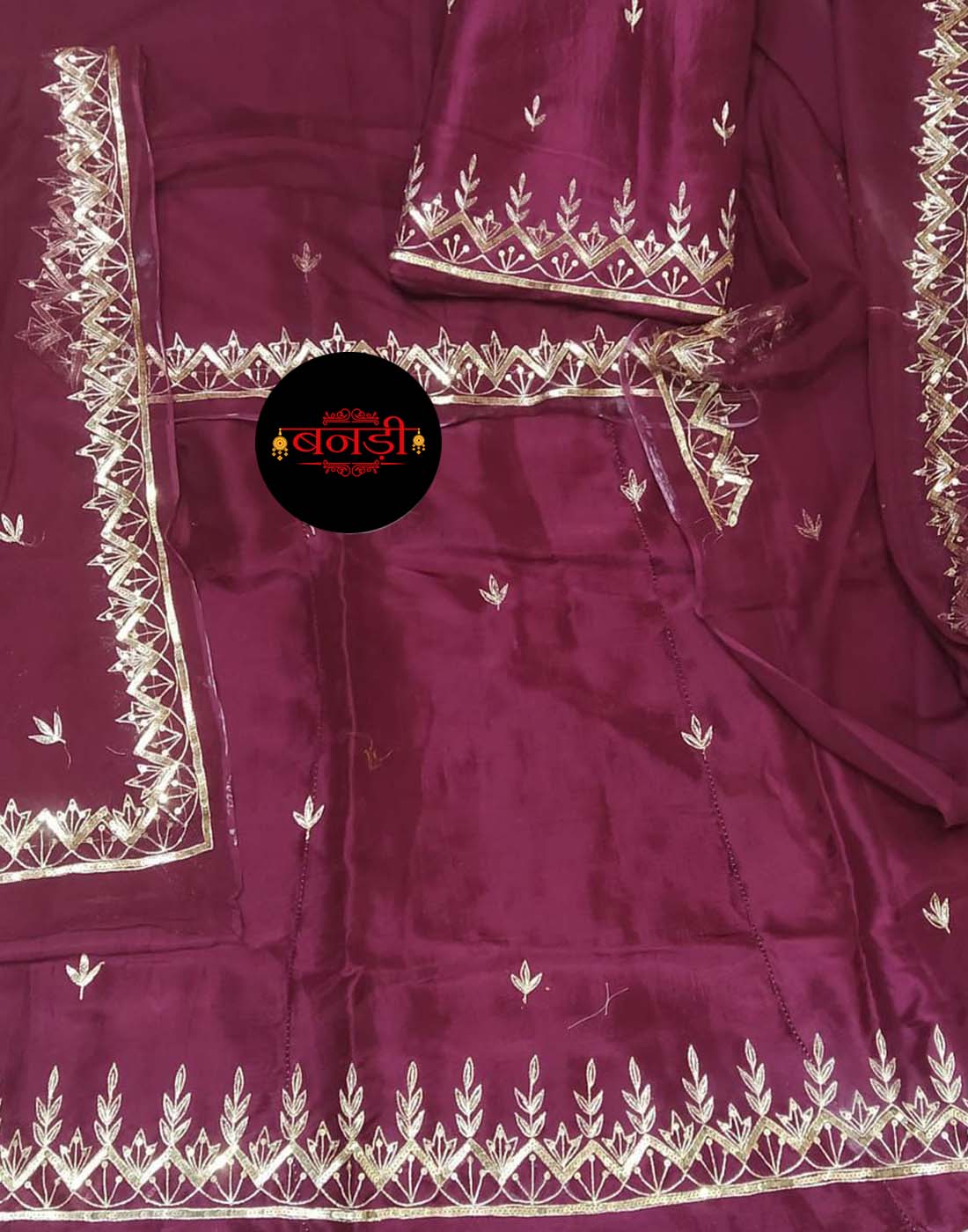 Our Dark Maroon Upada Suit is a masterpiece of Rajasthani craftsmanship. This rich, regal color is the epitome of elegance, beautifully complemented by intricate Jodhpur Tikli handwork. Crafted from the finest Upada fabric, this Rajputi poshak offers both